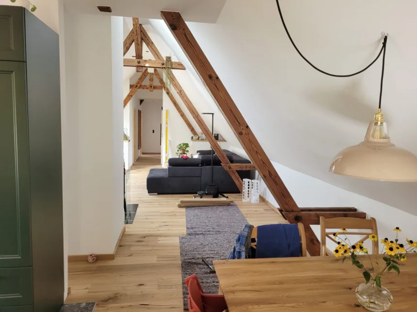 Essbereich und Wohnraum im Dachgeschoss, alte Sparren und neue Einbauten